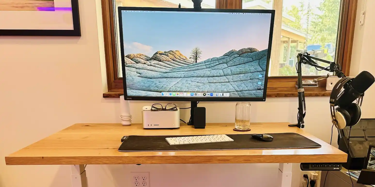 Structured desk layout with monitor, peripherals, and organized surface zones